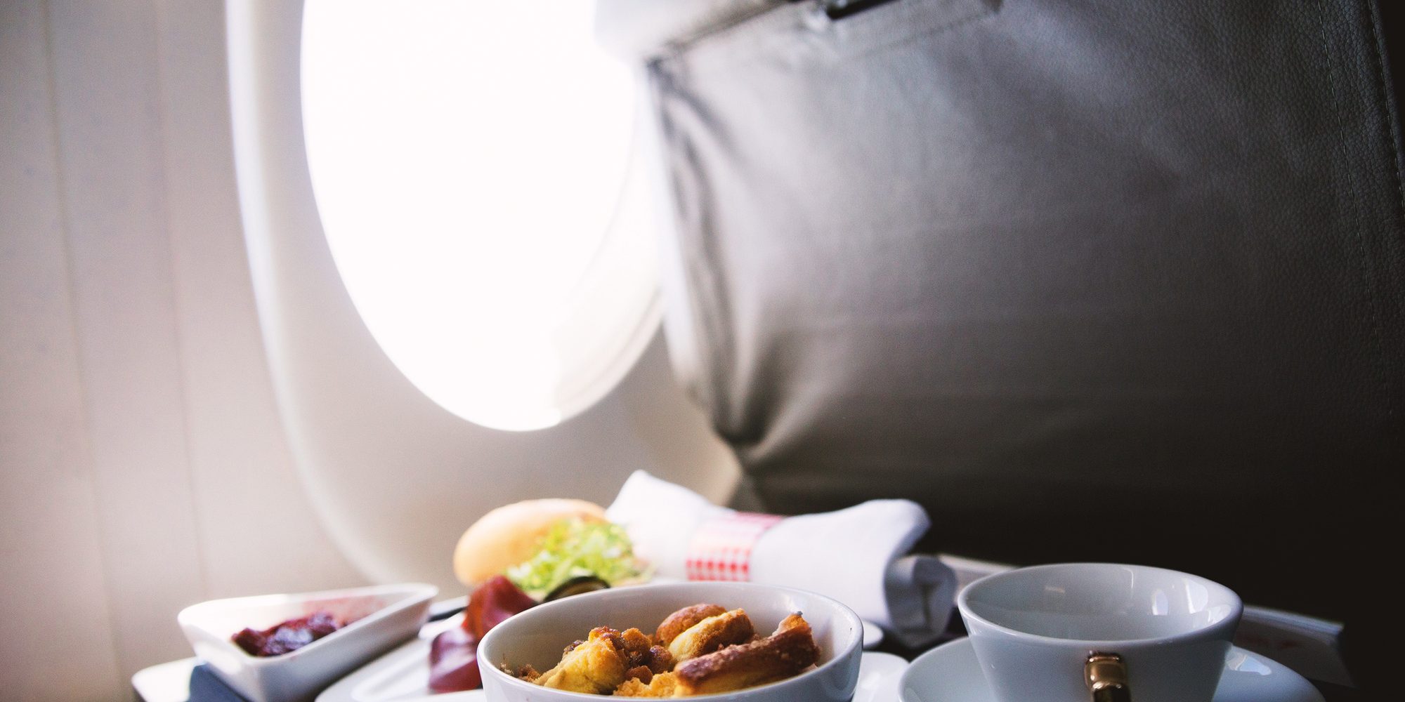 Food served on board of business class airplane on the table in-flight meals
