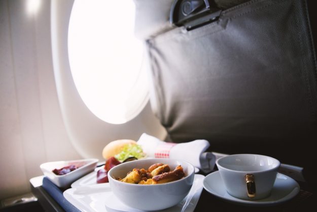 Food served on board of business class airplane on the table in-flight meals